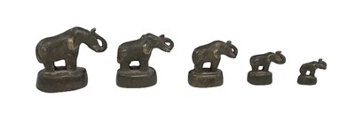 Lot 523 - A graduated set of six Benin type bronze...