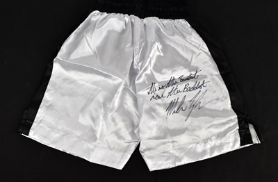 Lot 317 - MIKE TYSON; a pair of shorts, signed and...