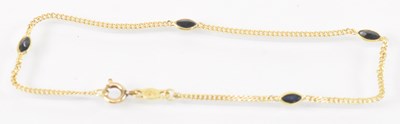 Lot 804 - An 18ct yellow gold onyx set bracelet, length...