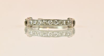 Lot 1276 - A white metal diamond half eternity ring set...