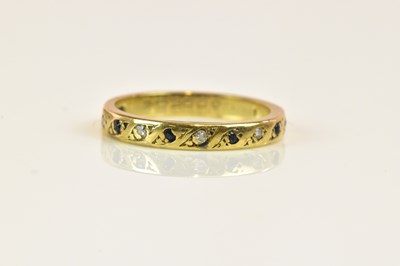 Lot 1281 - A yellow metal half eternity ring set with...