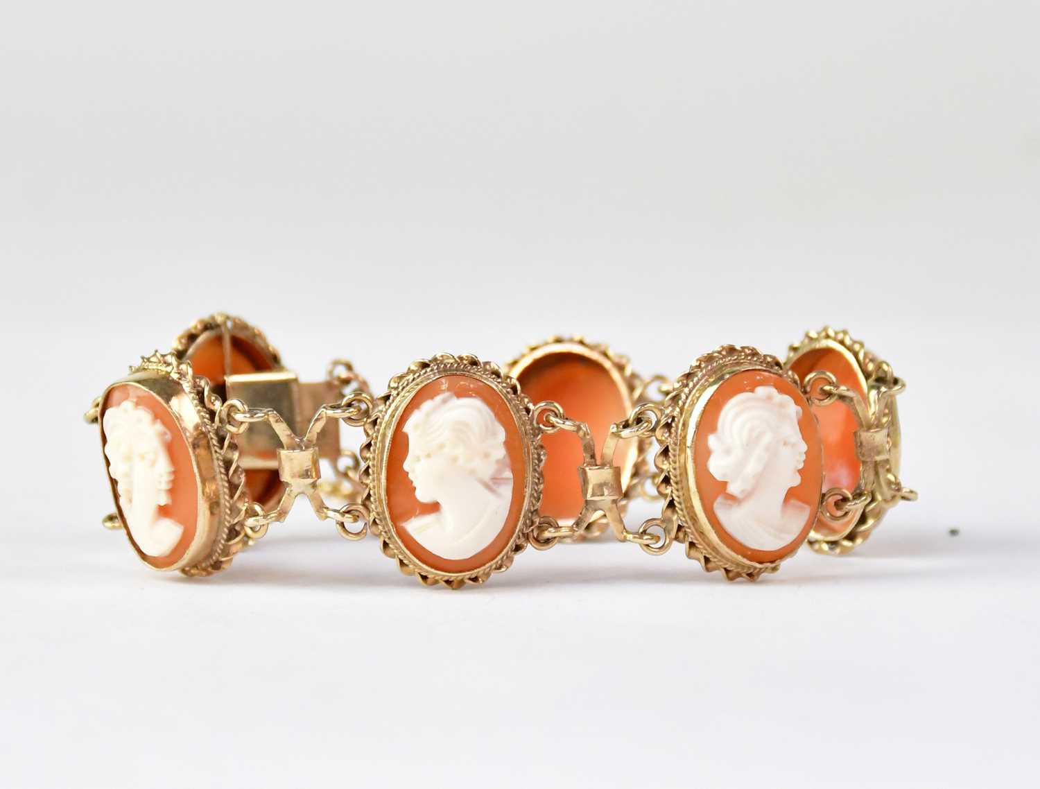 Lot 1135 - A 9ct gold cameo bracelet with six bezel set...