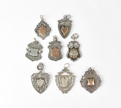 Lot 1304 - Eight hallmarked silver shield-shaped pocket...