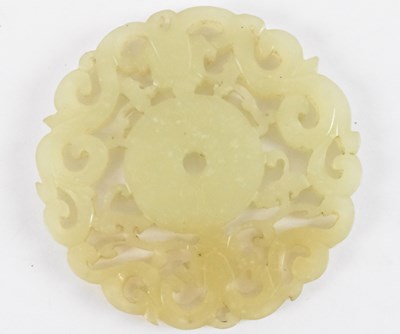 Lot 1033 - A Chinese carved jade bi disc, decorated with...