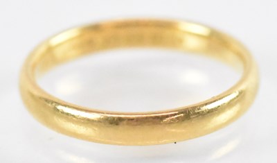 Lot 747 - A 22ct yellow gold wedding band, size L,...