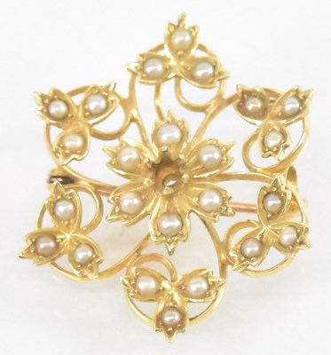 Lot 854 - A 15ct yellow gold seed pearl set flower...