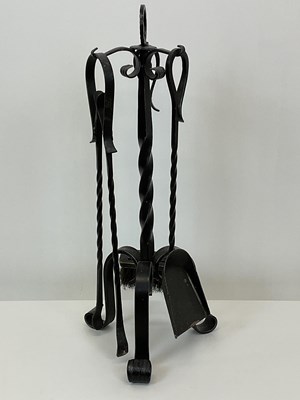 Lot 106 - A contemporary forged steel fireside companion...