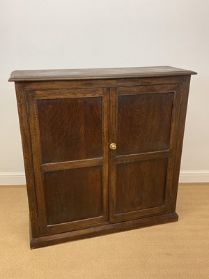 Lot 858 - An oak cupboard with three internal shelves,...