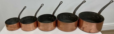 Lot 107 - A graduated set of five French copper pans,...