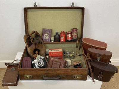 Lot 31 - A vintage leather suitcase containing...