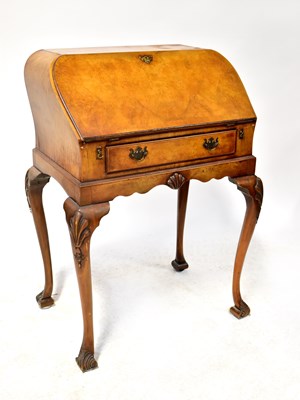 Lot 60 - An early 20th century walnut veneered drop-front bureau