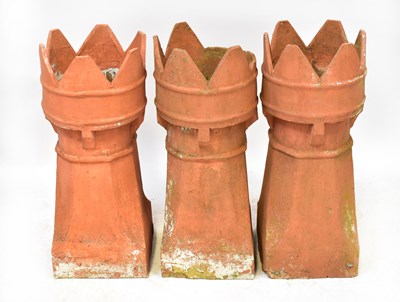 Lot 117 - Three terracotta castle-topped chimney pots,...