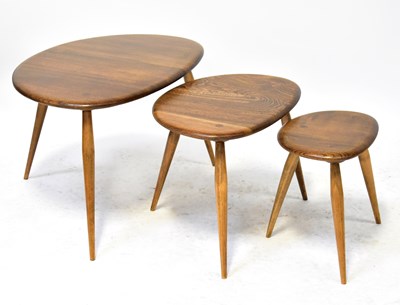 Lot 9 - ERCOL; a 1960s elm pebble nest of tables on...