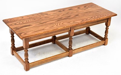 Lot 47 - An elm coffee table with rectangular top on...