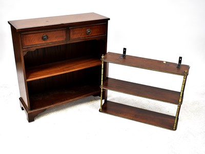 Lot 17 - A small mahogany two-drawer bookcase raised on bracket feet