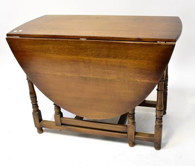 Lot 49 - A Georgian-style oak gateleg drop-leaf supper...