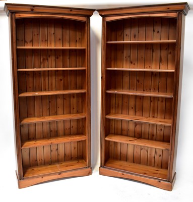 Lot 83 - A pair of waxed pine tall bookcases of six...