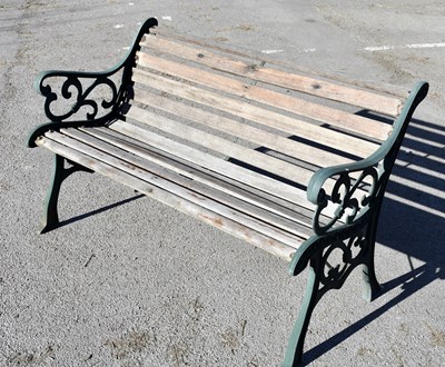 Lot 2694 - A modern garden bench with wooden slats and...