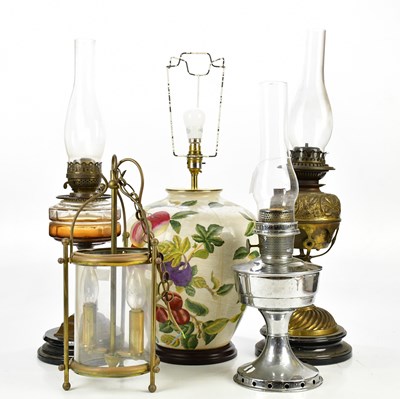 Lot 1535 - Three decorative oil lamps including a brass...