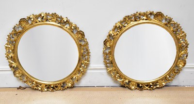 Lot 1045 - A pair of gilt gesso circular wall mirrors...