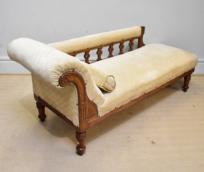 Lot 1033 - A late Victorian oak framed chaise longue,...