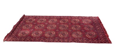 Lot 1257 - An Eastern style red ground rug with geometric...