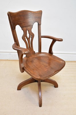 Lot 1188 - A 1920s oak office swivel chair, height 104cm.