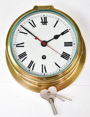 Lot 310 - A brass porthole clock, the dial set with...