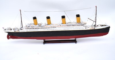 Lot 252 - RMS TITANIC; a wooden model with four funnels...