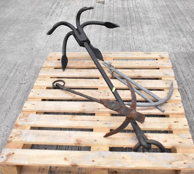 Lot 297 - Three various metal boat anchors, length of...