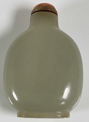 Lot 266 - A Chinese carved jade snuff bottle with coral...