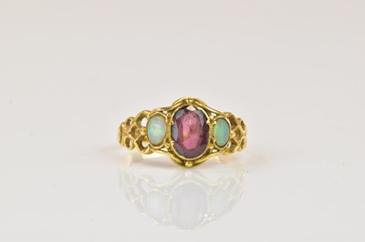 Lot 1286 - A yellow metal amethyst and opal three stone...