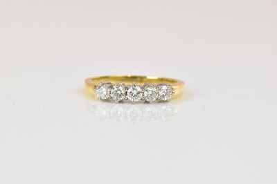 Lot 1288 - An 18ct yellow gold five stone diamond ring,...