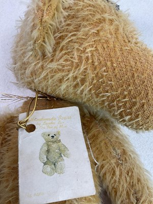 Lot 137 - A large gold plush teddy bear with weighted...
