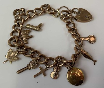 Lot 1248 - A 9ct rose gold charm bracelet set with...