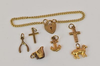 Lot 1255 - A group of 9ct gold and yellow metal charms...