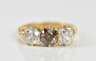 Lot 1269 - A yellow metal three stone diamond ring with...