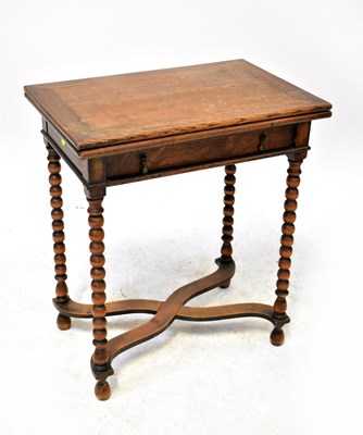 Lot 39 - A small oak fold-over card table