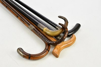 Lot 1453 - A group of six walking sticks, five with...