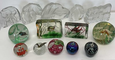 Lot 241 - A group of glass paperweights, comprising four...