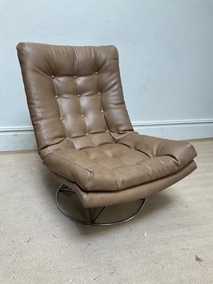 Lot 1225 - A vintage brown leather chair on circular...