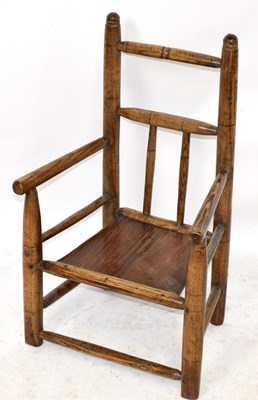 Lot 2556 - A 19th century child's elm spindle back elbow...