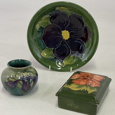 Lot 153 - MOORCROFT; a squat green ground posy vase in...