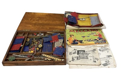 Lot 582 - MECCANO; a box of assorted Meccano parts and...