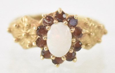 Lot 1318 - A 9ct yellow gold opal and garnet set ring,...