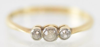 Lot 1316 - An 18ct yellow gold ring set with three white...