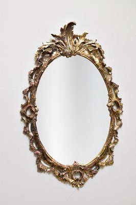 Lot 1034 - An ornate gilt framed oval wall mirror, 113 x...