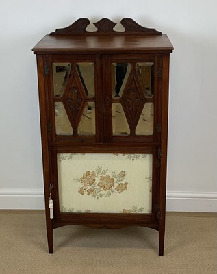 Lot 867 - A mahogany music cabinet, with twin doors with...