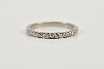 Lot 90 - A platinum and diamond half eternity ring,...