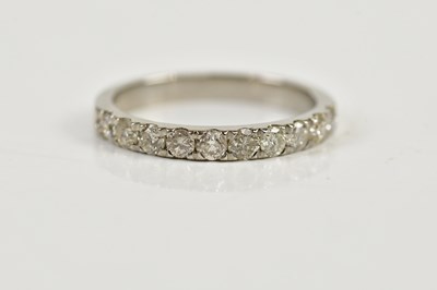 Lot 91 - A platinum and diamond half eternity ring,...